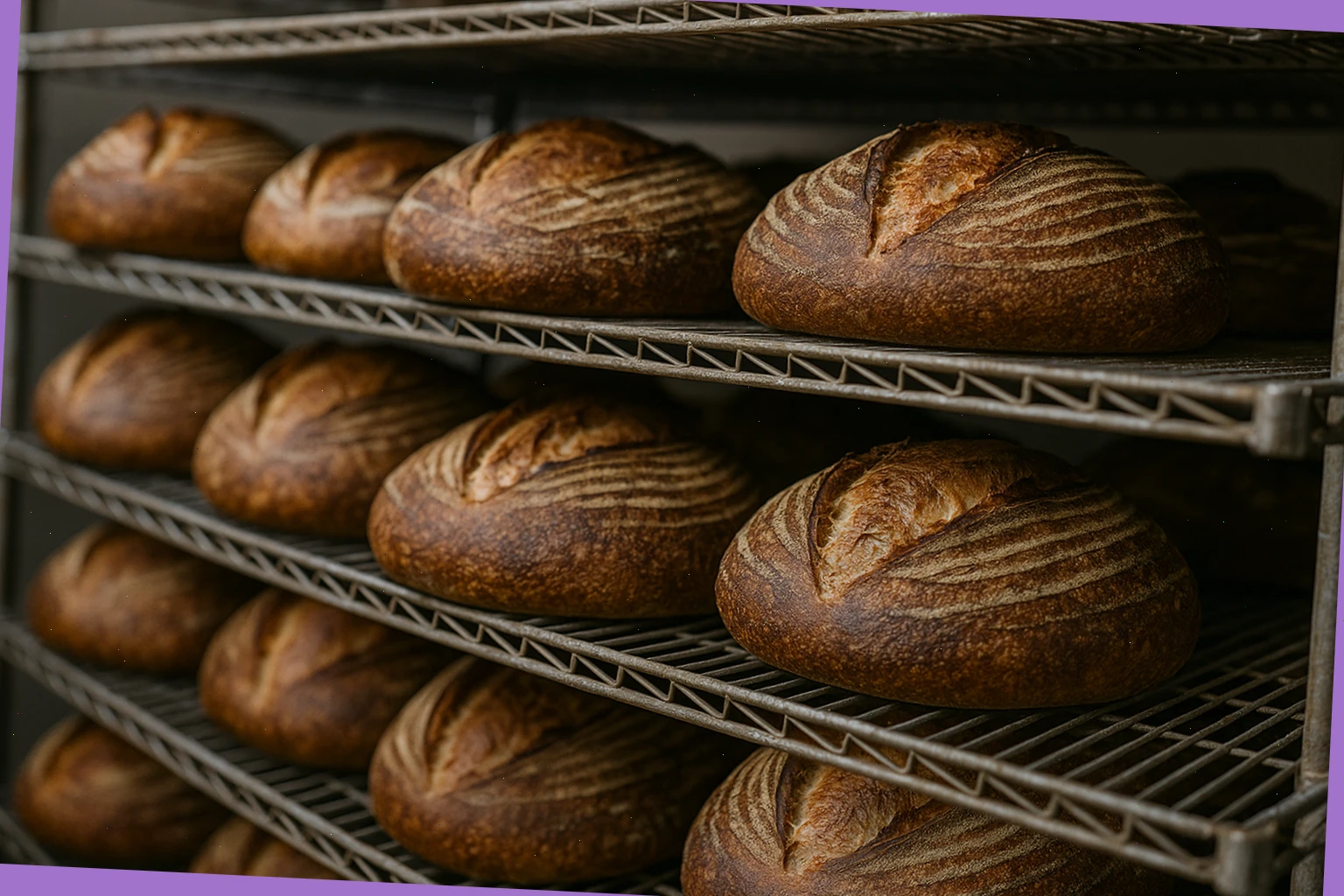 Stack of sourdough loaves cooling on wire racks